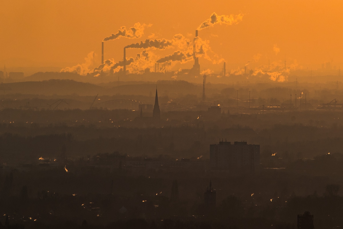 Steam and exhaust rise from heavy industry over the town of Oberhausen, Germany