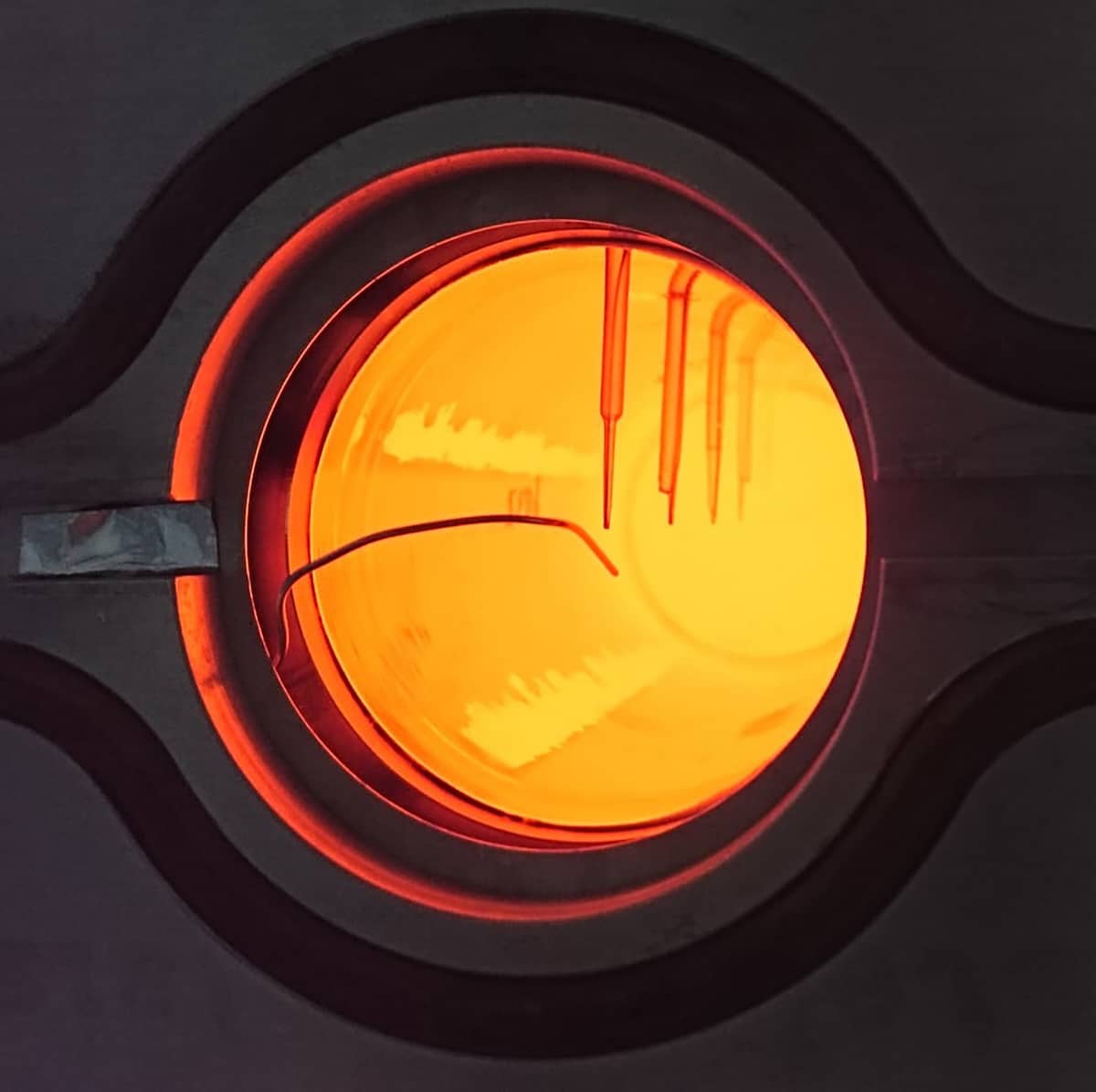 A glowing quartz rod at the end of an experiment in absorbing solar radiation, in which it reached a temperature of 1,050°C. Solar process heat above 1,000°C can decarbonize industrial applications such as cement manufacturing and metallurgical extraction